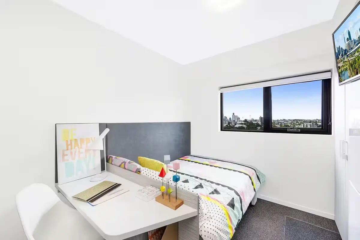 Bed desk with lamp and chair bedroom at Scape Regent in Brisbane Student Accommodation