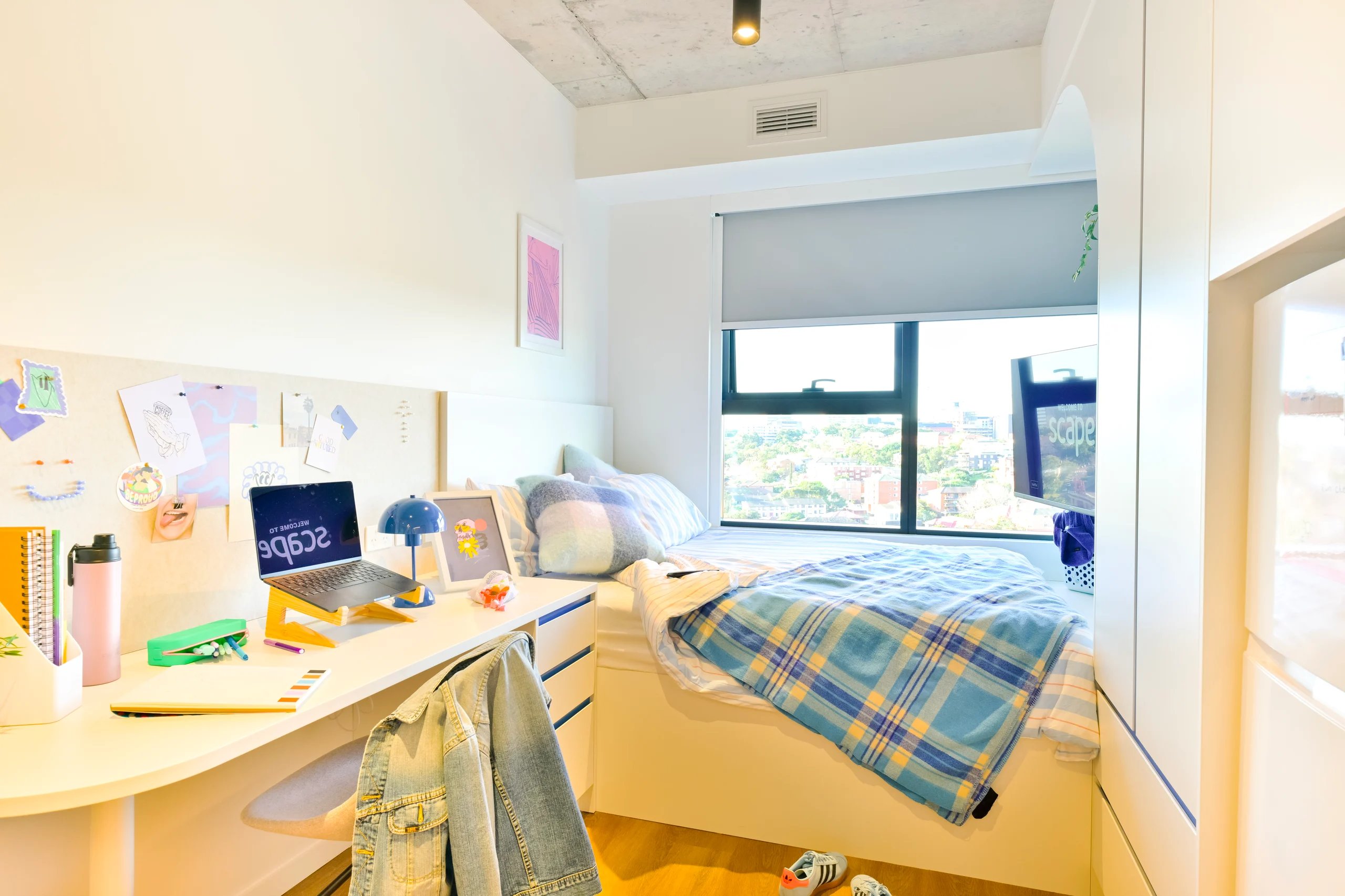 Desk with laptop and bed Bedroom Image at Scape Kingsford in Sydney Student Accommodation