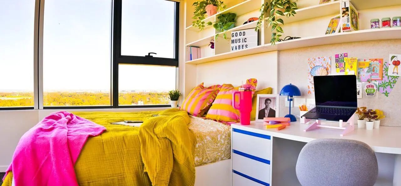 Bright bed desk and shelves with laptop bedroom at Scape Kingsford in Sydney Student Accommodation