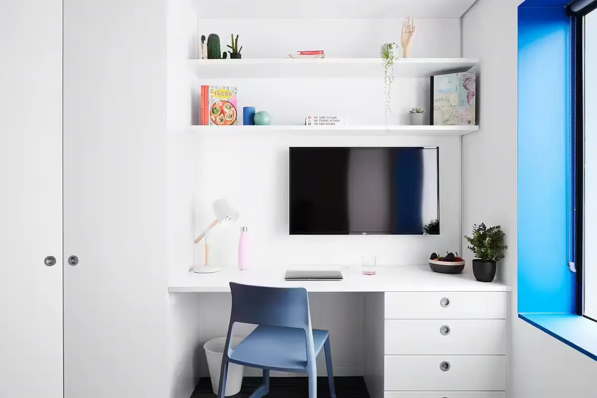 Desk chair shelves television study area bedroom at Scape Swanston in Melbourne Student Accommodation