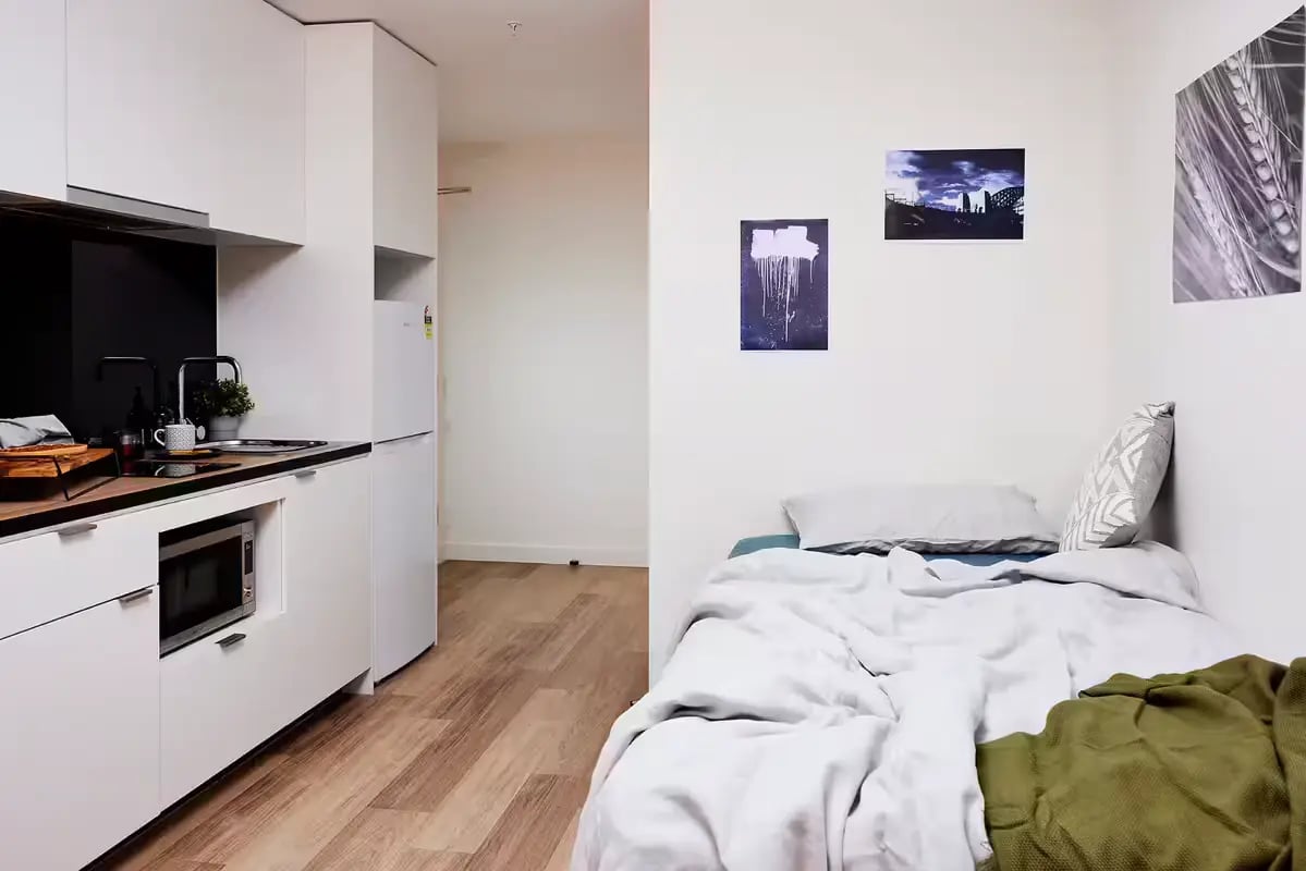 Kitchenette with bed and artwork Bedroom at Scape La Trobe in Melbourne Student Accommodation