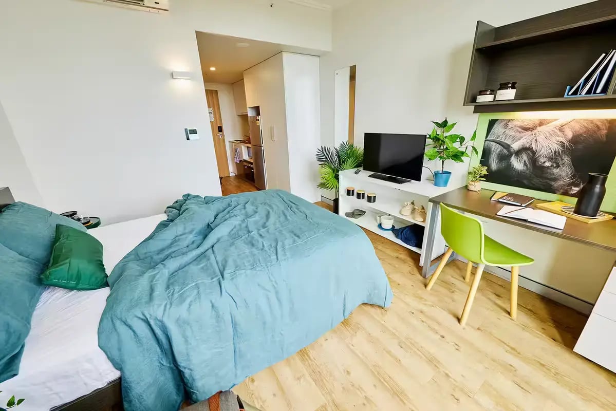 Bed desk TV and kitchen area studio apartment at Scape at University of Sydney in Sydney Student Accommodation