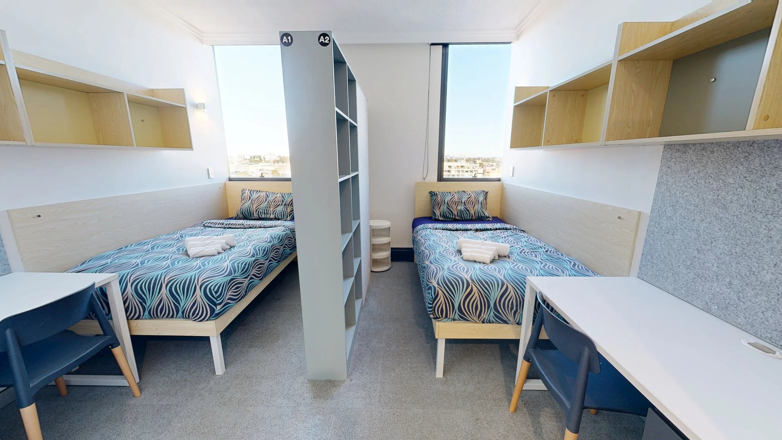 Two beds desk shelves and partition bedroom at Scape Darling Square in Sydney Student Accommodation