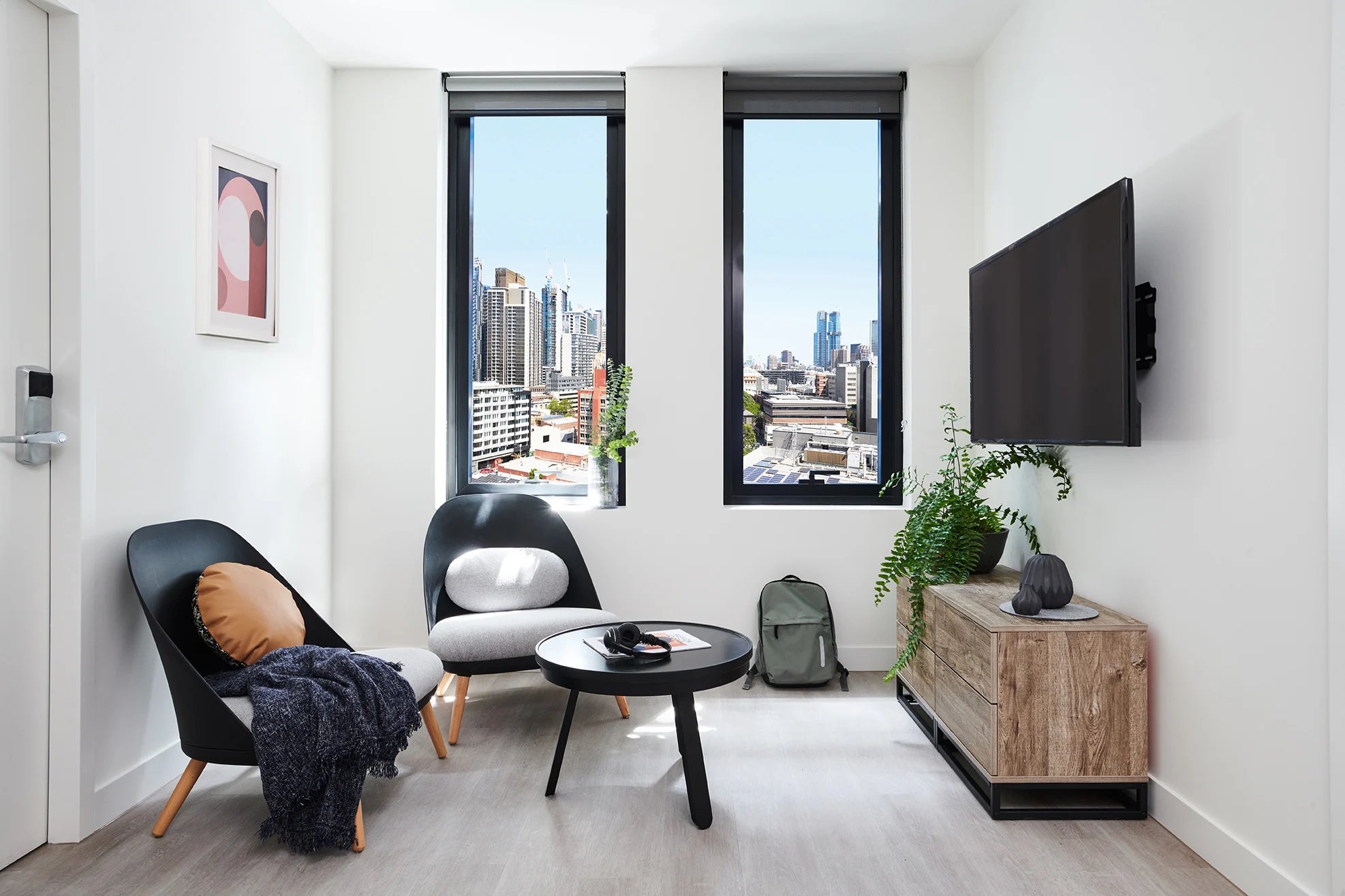 Chairs, table, TV, backpack, plant Living room at Scape Cornell Place in Melbourne Student Accommodation