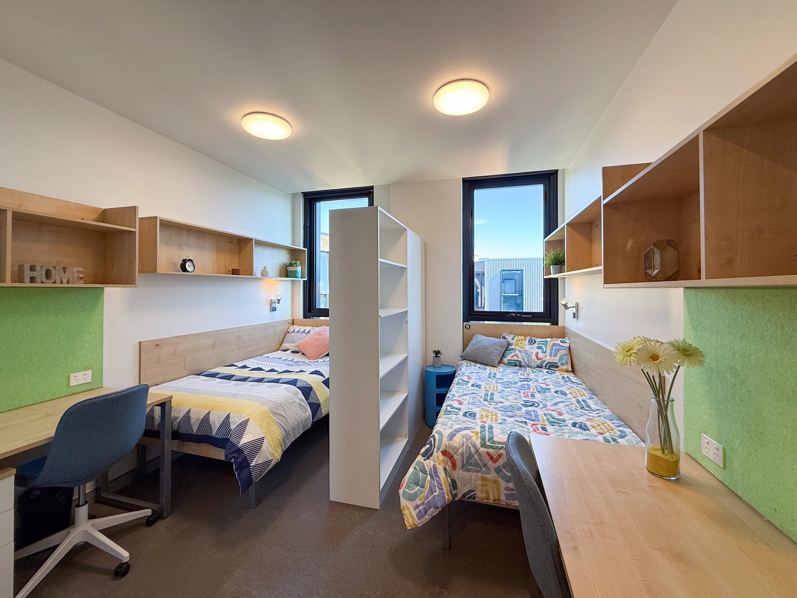 Two beds desks shelves and windows Bedroom at Scape Cleveland in Sydney Student Accommodation