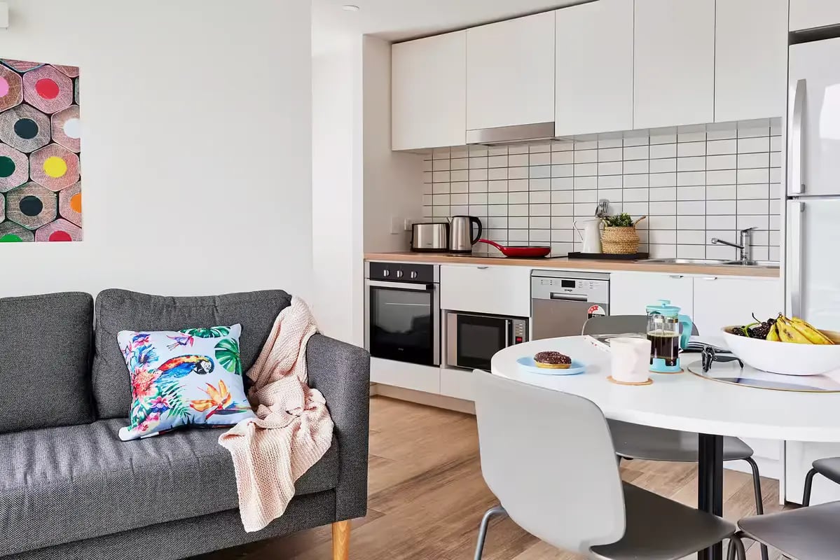 Sofa kitchen appliances dining table living room kitchen at Scape Peel in Melbourne Student Accommodation
