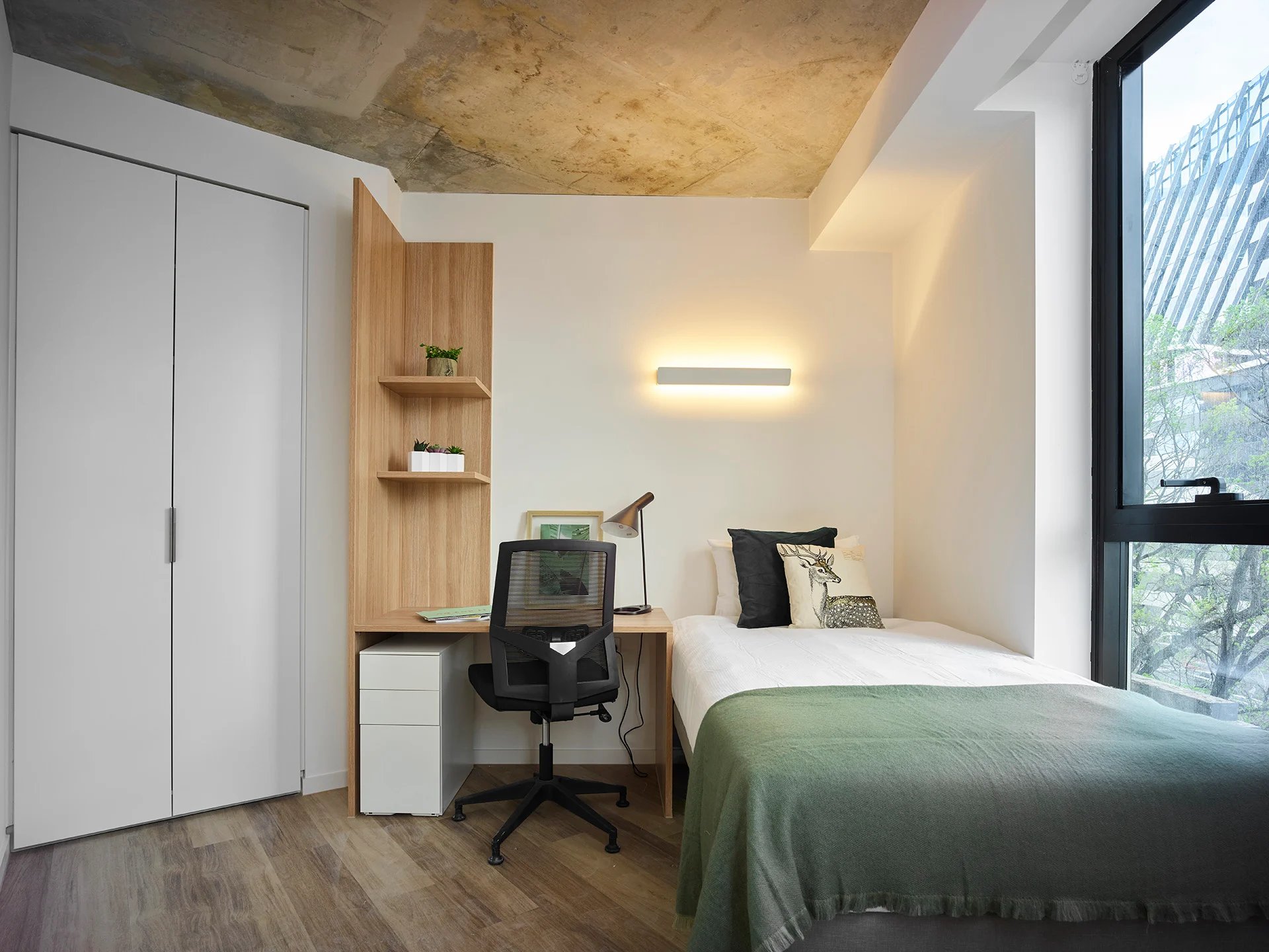 Desk chair bed and wardrobe student bedroom at Scape Peel in Melbourne Student Accommodation