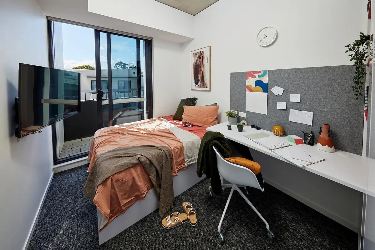 Bed desk TV balcony and window bedroom at Scape Redfern in Sydney Student Accommodation
