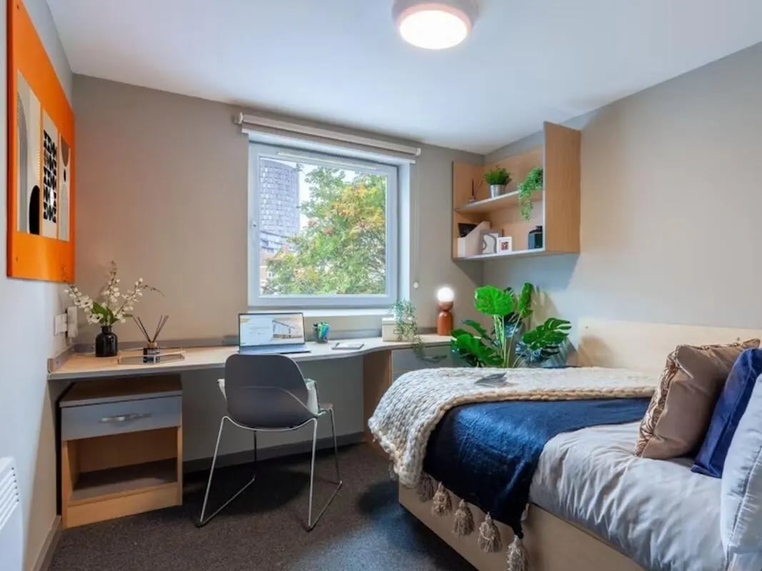 Bed desk chair and artwork student bedroom at Filbert Village in Leicester Student Accommodation