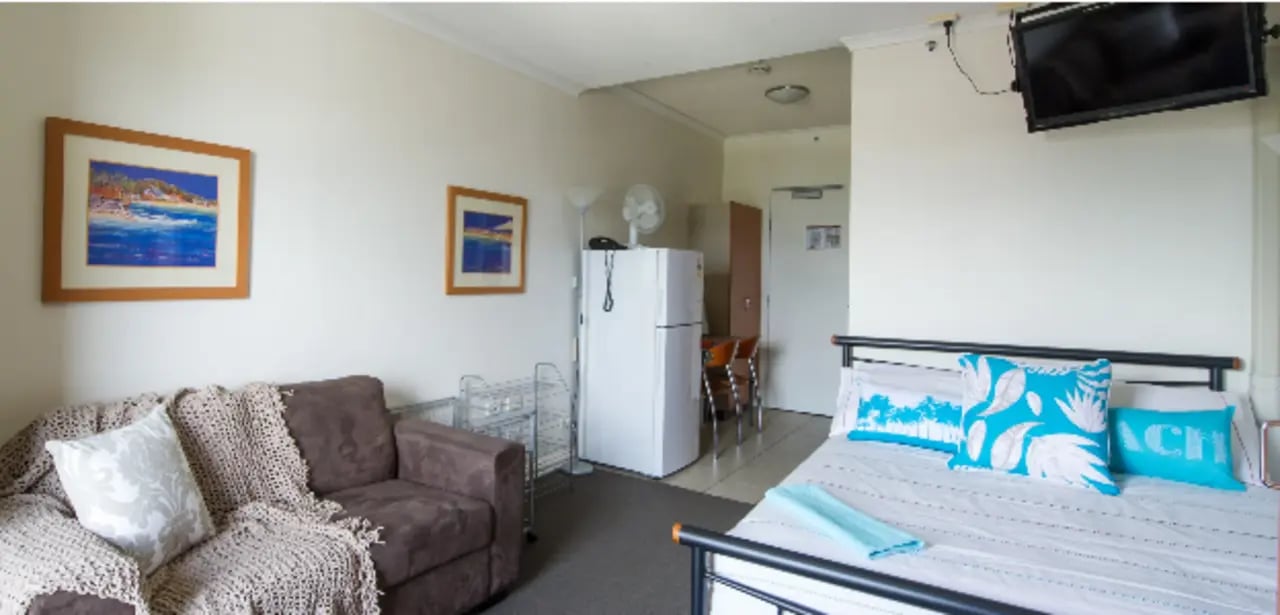 Sofa fridge bed art and TV room at Student Living - Shafston in Brisbane Student Accommodation
