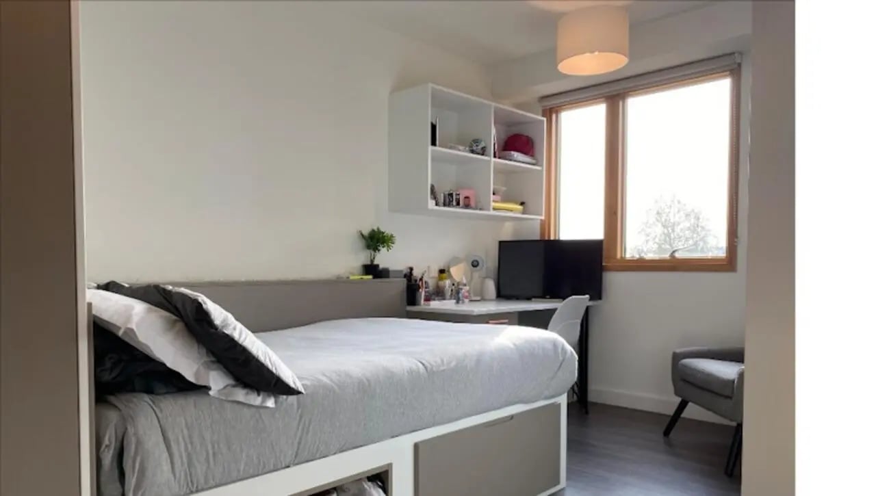 Bed desk chair shelves window bedroom at Charles Morton Court in London Student Accommodation