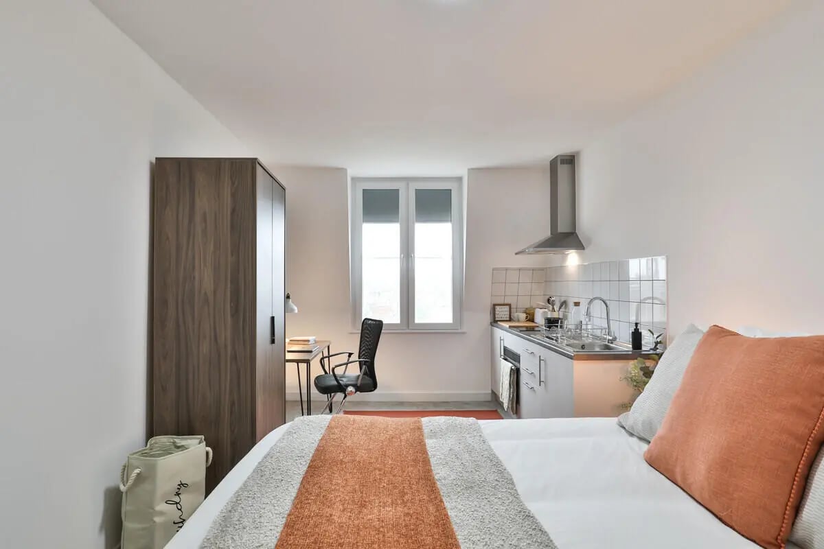 Wardrobe desk chair kitchen counter sink studio apartment at Francis Gardner in London Student Accommodation