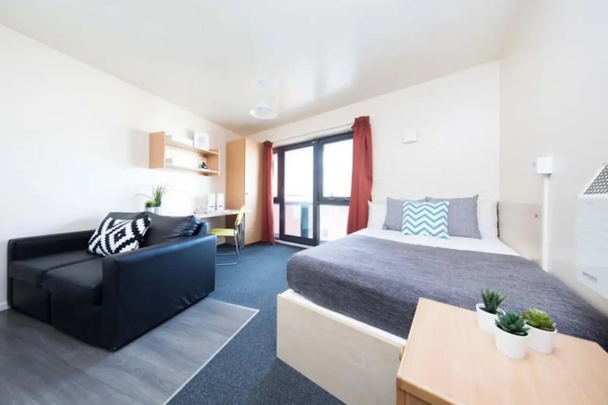 Bed desk couch and shelves bedroom at Devonshire Courtyard in Sheffield Student Accommodation
