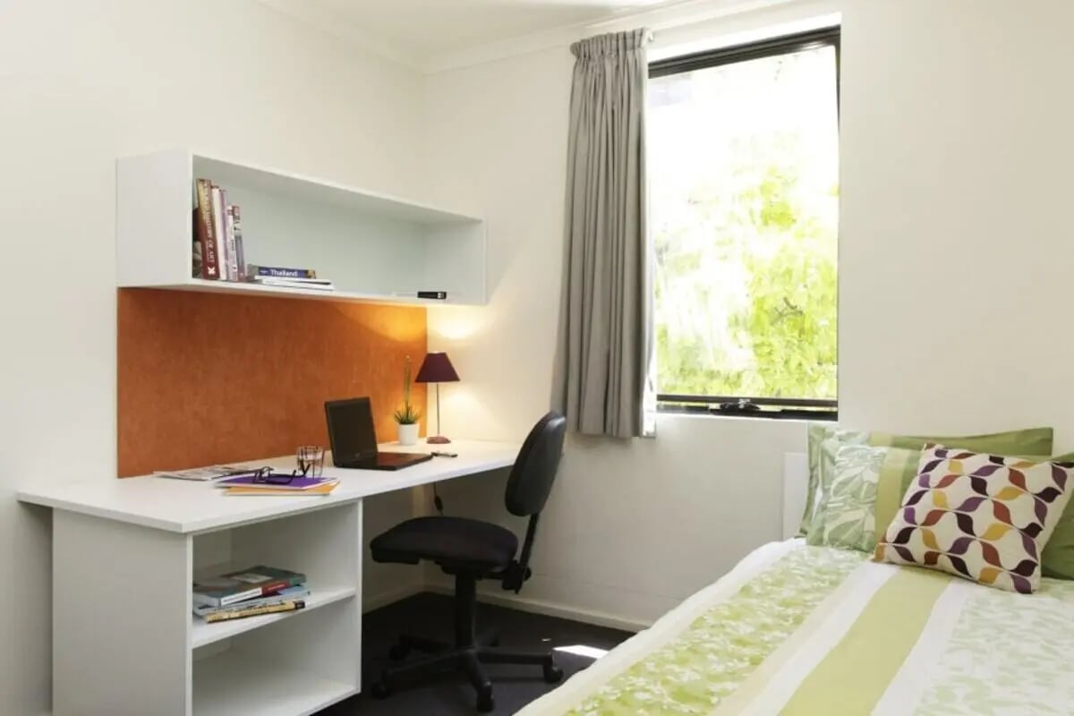 Desk with laptop shelving and bed Bedroom at Sydney University Village in Sydney Student Accommodation