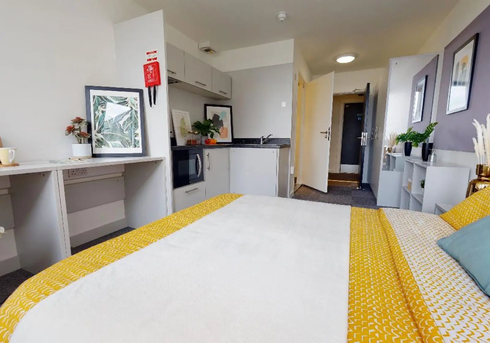 Bed with kitchenette and desk studio apartment at iQ Newtown House in Nottingham Student Accommodation
