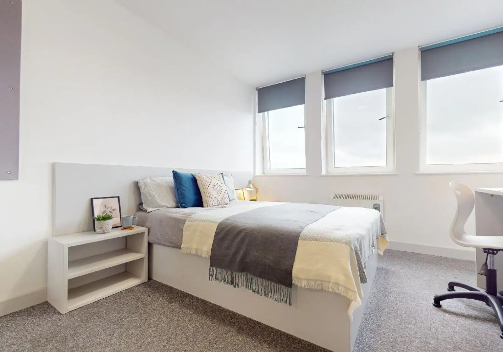 Bed with pillows nightstand desk and chair bedroom at iQ Newtown House in Nottingham Student Accommodation