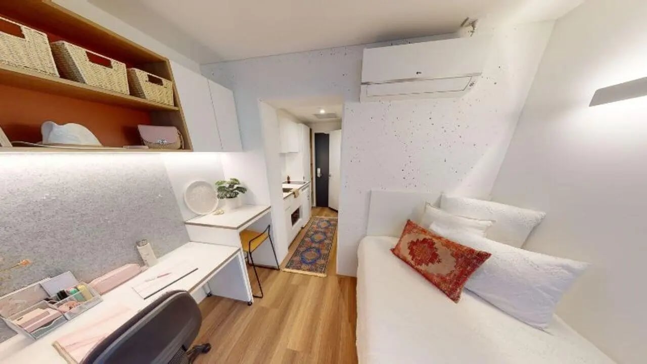 Desk bed kitchenette with rug and shelving studio at UniLodge Melbourne Flagstaff in Melbourne Student Accommodation