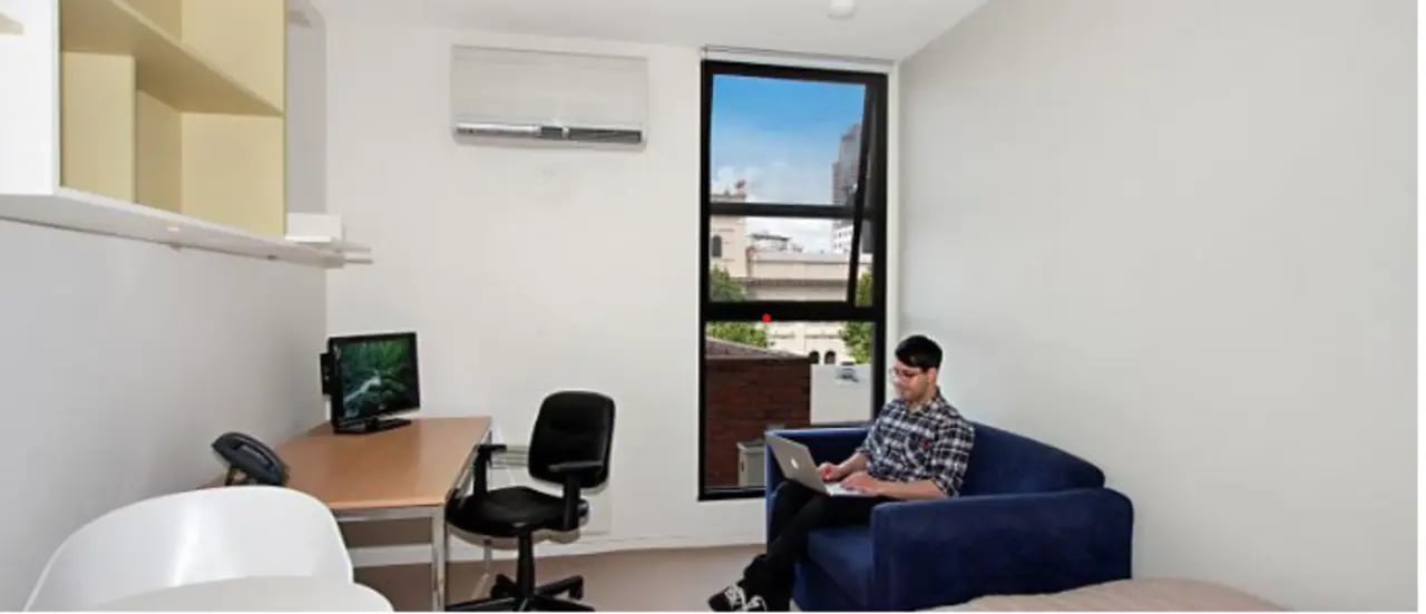 Desk with computer and sofa bedroom at Student Living On Campus in Melbourne Student Accommodation