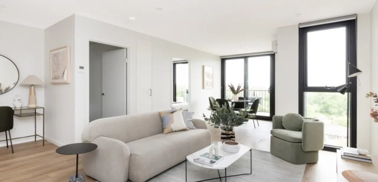 Sofa coffee table chairs windows living room at Dickson Village Apartments in Canberra Student Accommodation