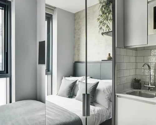 Bed with sink and cabinets Bedroom kitchen at ARK Canary Wharf in London Student Accommodation