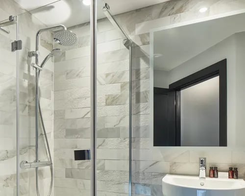 Shower with modern fixtures and sink bathroom at ARK Canary Wharf in London Student Accommodation