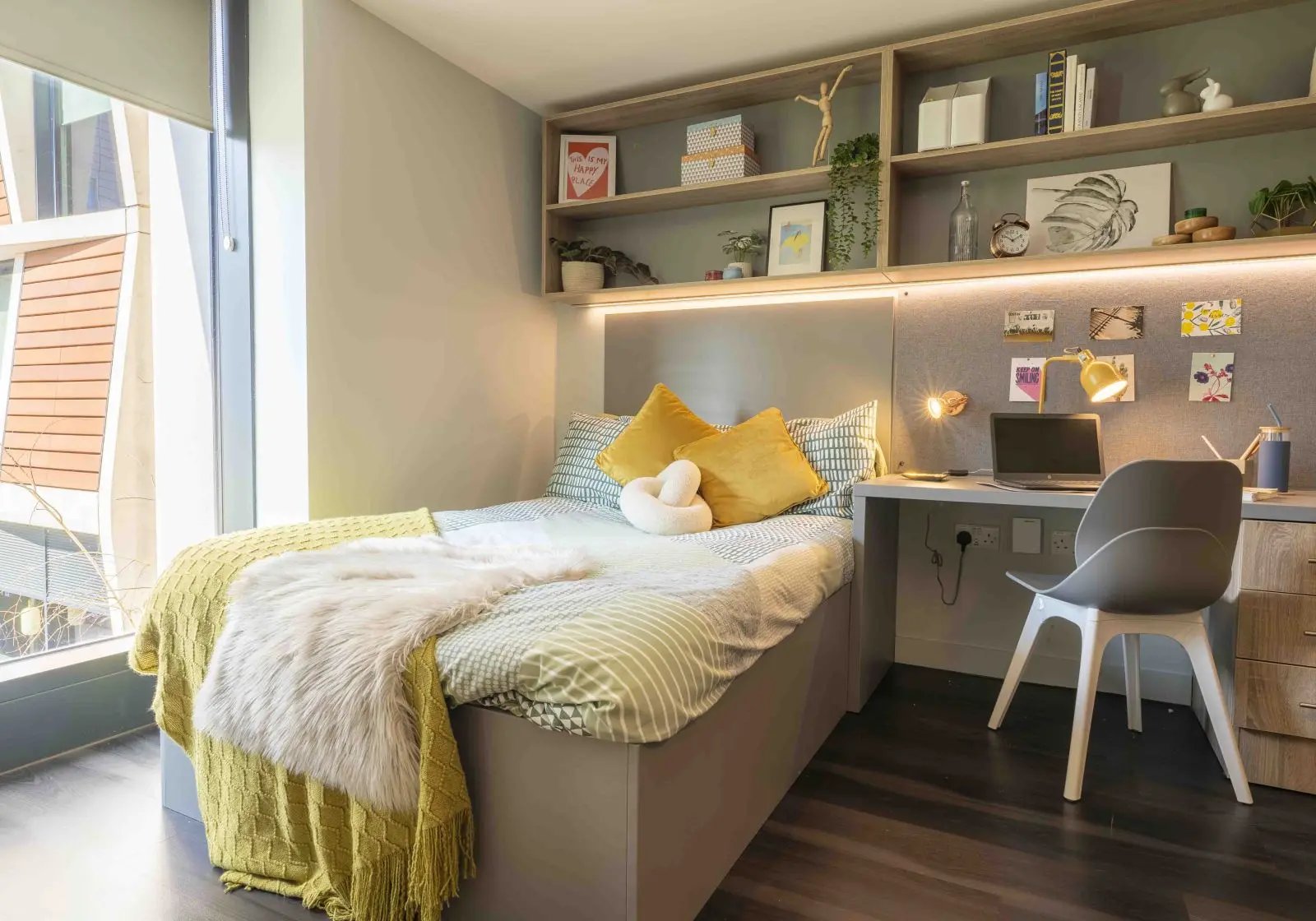 Bed desk with laptop and shelves bedroom at iQ Aldgate in London Student Accommodation
