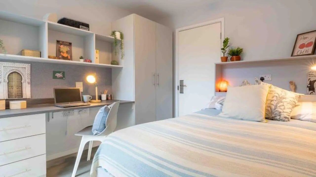 Bed desk wardrobe and shelves bedroom at iQ City in London Student Accommodation