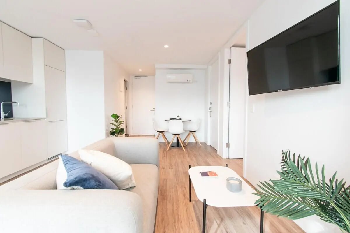 Sofa coffee table dining set television living room at UniLodge Park Avenue in Melbourne Student Accommodation