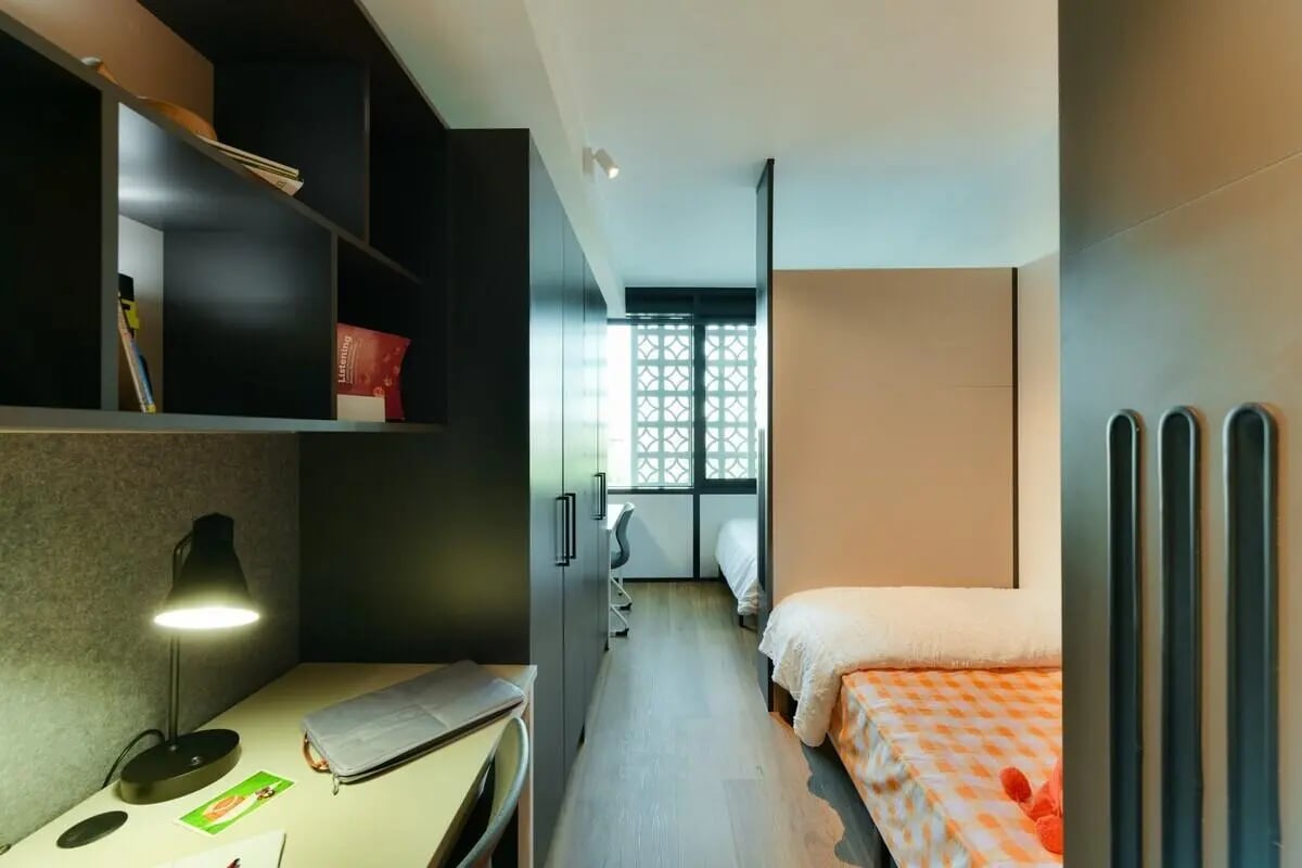 Desk lamp shelves and bed in student accommodation bedroom at UniLodge Toowong in Brisbane Student Accommodation