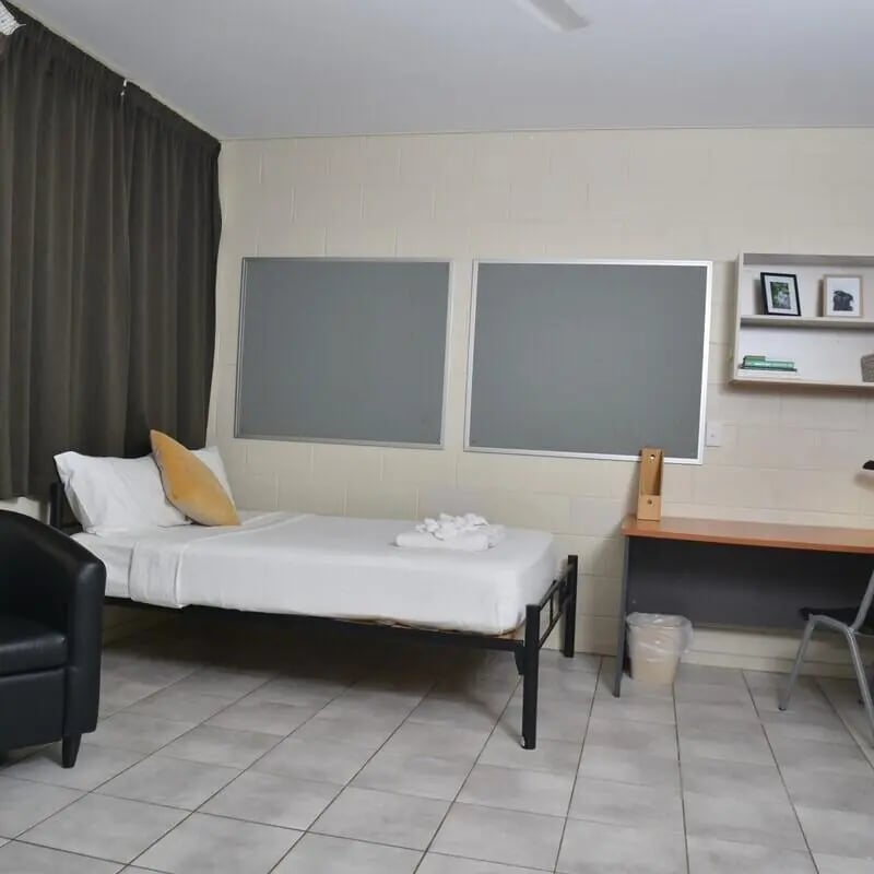 Bed desk and bulletin boards student room at CDU Village Casuarina in Darwin Student Accommodation
