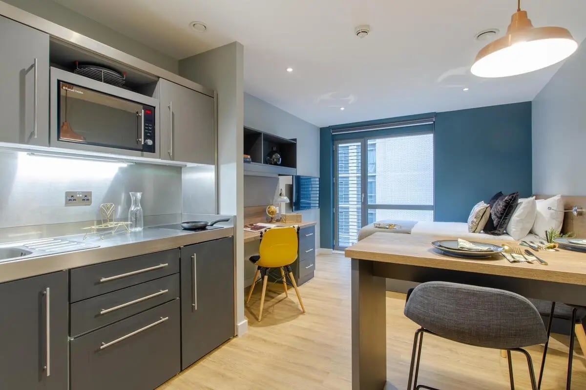 Studio kitchen desk bed and dining table interior at Crown House in Sheffield Student Accommodation
