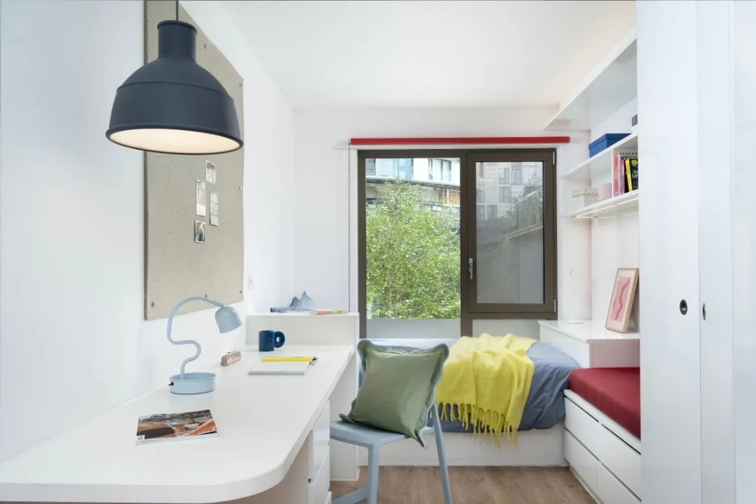 Desk lamp bed and shelves bedroom at Scape Wembley in London Student Accommodation