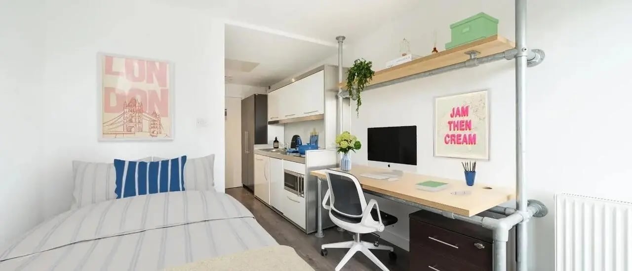 Bed kitchen desk computer and chair studio apartment at Chapter Spitalfields in London Student Accommodation