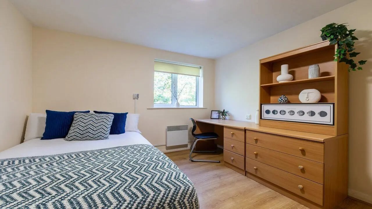 Bed desk and dresser student accommodation bedroom at Weston Court in Manchester Student Accommodation