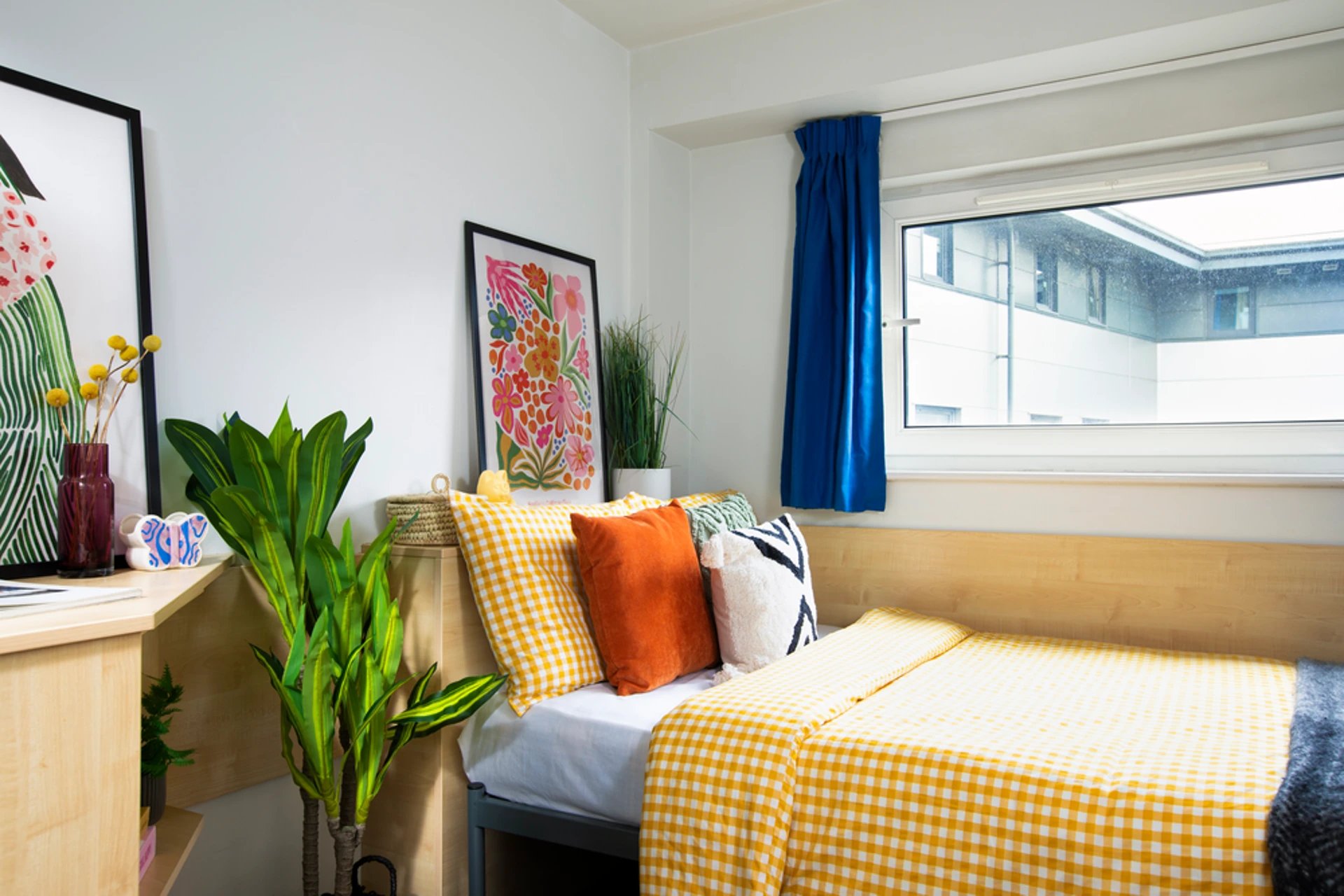 Bed with yellow gingham bedding and pillows bedroom at Liberty Park in Leicester Student Accommodation