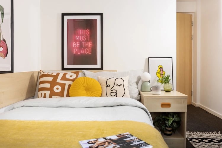 Bed with pillows artwork and nightstand bedroom at Atlantic Point in Liverpool Student Accommodation