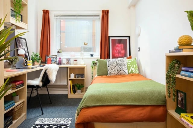 Desk chair bed with colorful blankets bedroom at Mary Sturge in Birmingham Student Accommodation