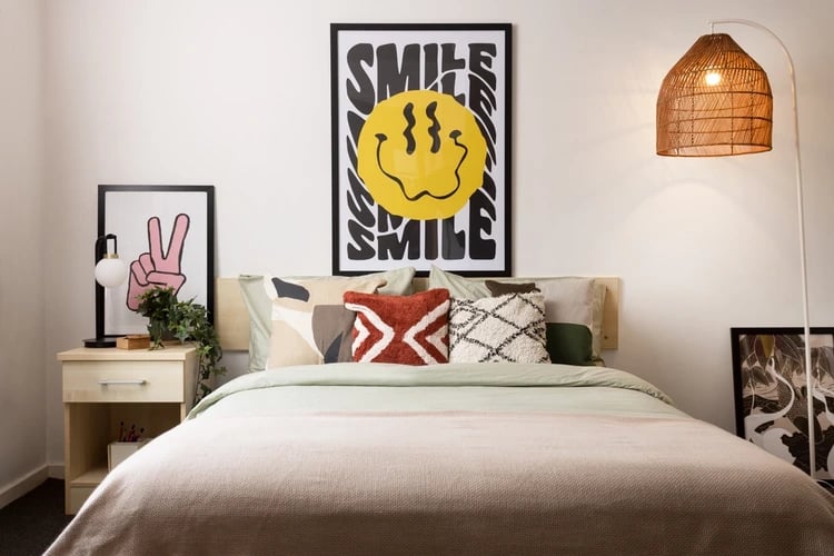Bed with posters and bedside table Bedroom at Atlantic Point in Liverpool Student Accommodation