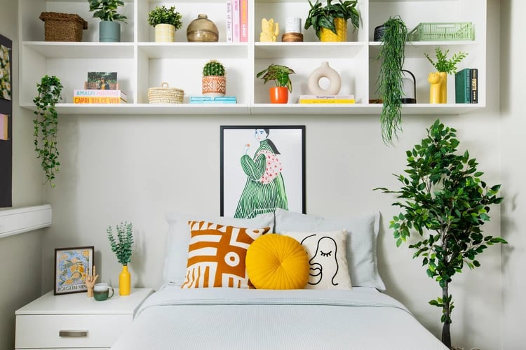 Bed with decorative pillows and artwork bedroom at East Central House in London Student Accommodation