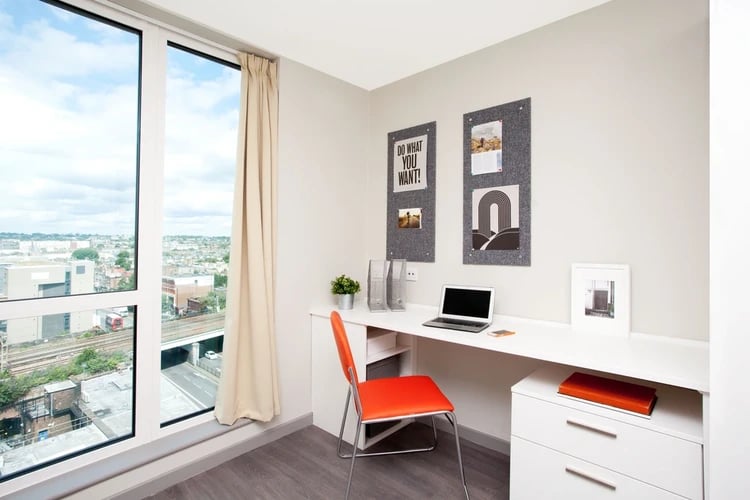 Desk chair laptop and notice boards study area at Stapleton House in London Student Accommodation