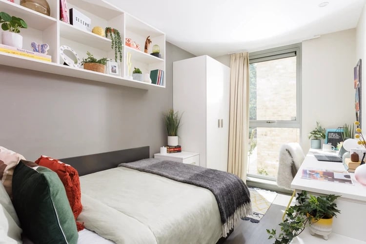 Bed shelves wardrobe desk chair and window bedroom at The Old Printworks in Edinburgh Student Accommodation