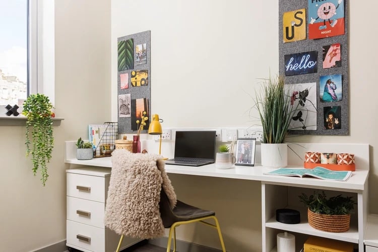 Desk with laptop, chair, and photos Study area at The Old Printworks in Edinburgh Student Accommodation