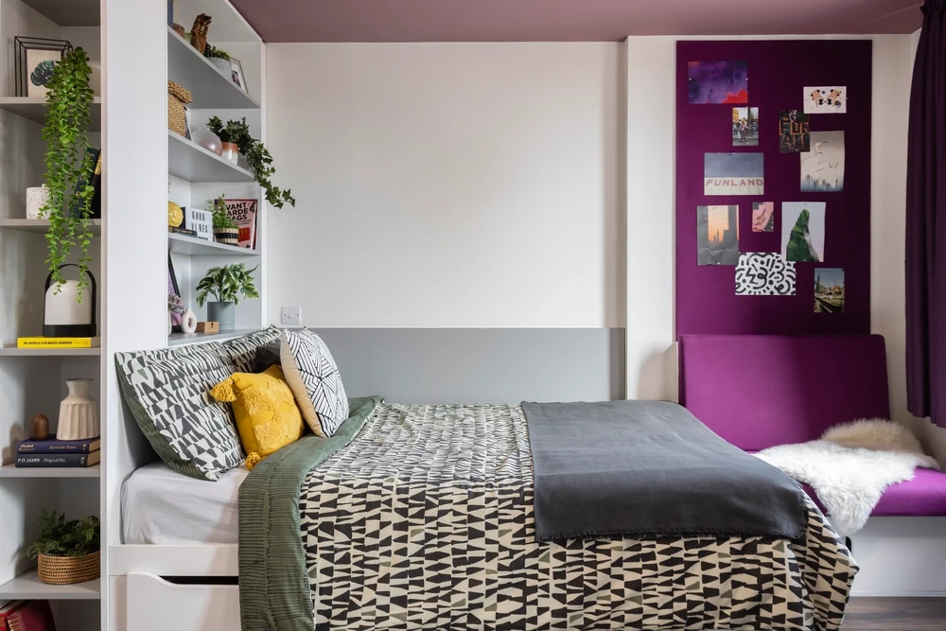 Bed with patterned bedding and purple seating area bedroom at Wellington St Plaza in Newcastle Upon Tyne Student Accommodation