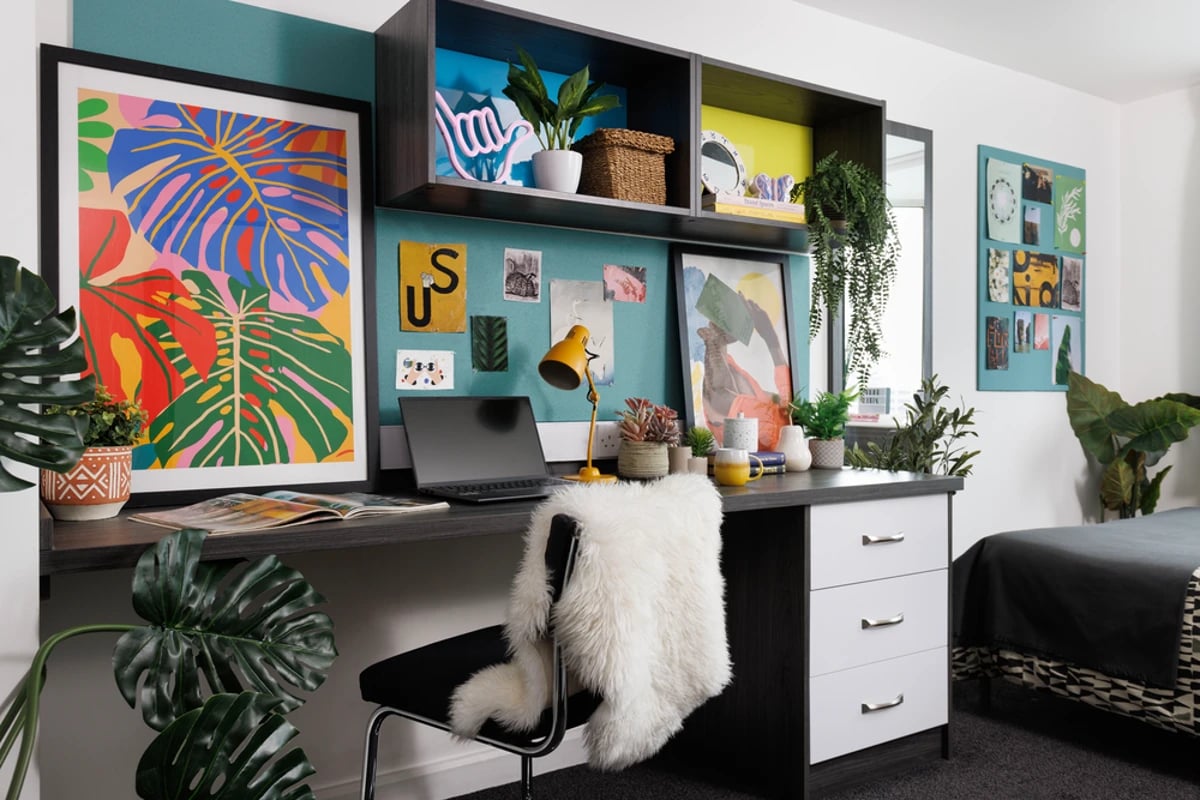 Desk with laptop plants and art study area at Hepworth Lodge in Leeds Student Accommodation