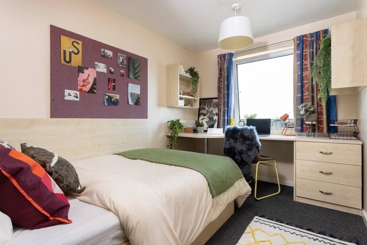 Bed desk chair and corkboard bedroom at The Plaza in Leeds Student Accommodation