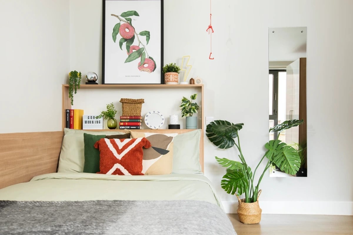 Bed with artwork plants and mirror bedroom at Kelvin Court in Glasgow Student Accommodation