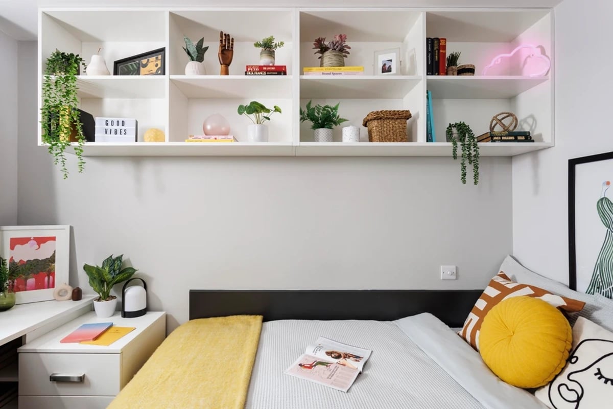 Shelves with plants and decor above bed Bedroom at Kincardine Court in Manchester Student Accommodation