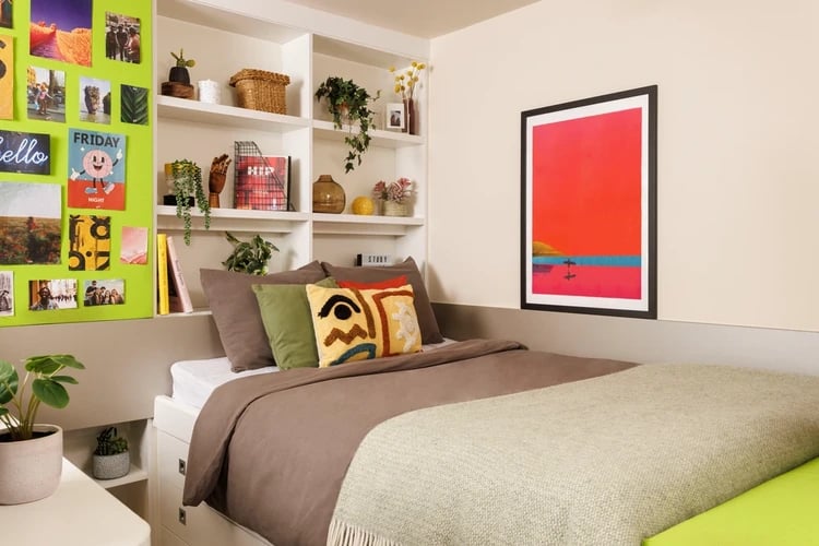 Bed with colorful pillows and artwork bedroom at Quay Point Studios in Newcastle Upon Tyne Student Accommodation