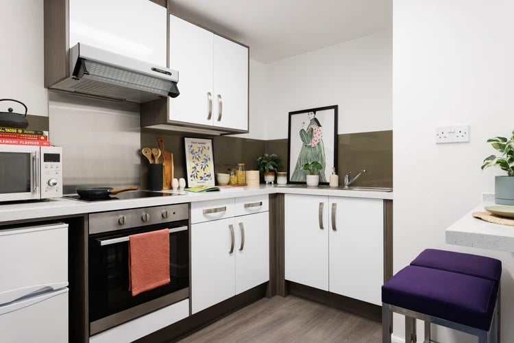Modern student kitchen with oven microwave and stool kitchen at Hepworth Lodge in Leeds Student Accommodation