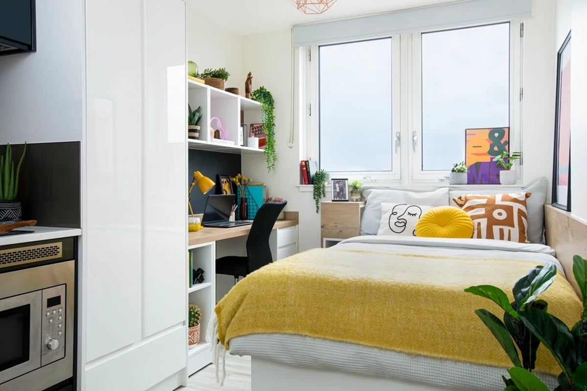 Bed desk shelf microwave kitchen bedroom at Walmsley Studios in London Student Accommodation